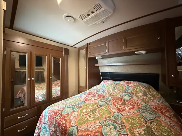 a bedroom with a bed and lamp with window