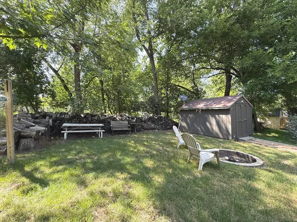 a backyard of a house with table and chairs