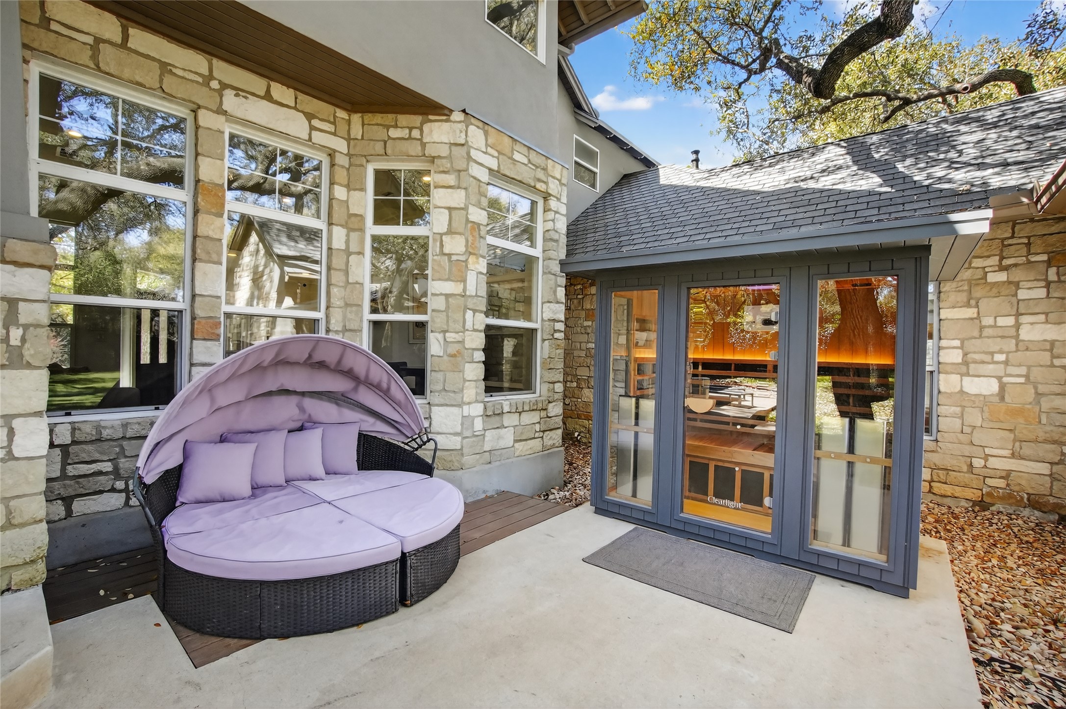 3627 Stoneridge Road Austin, TX 78746 - Photo 25 of 40 Doorway to property with stone siding, a patio area, and french doors