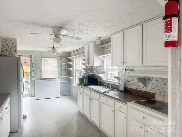 a kitchen with stainless steel appliances a white cabinets and a counter top space