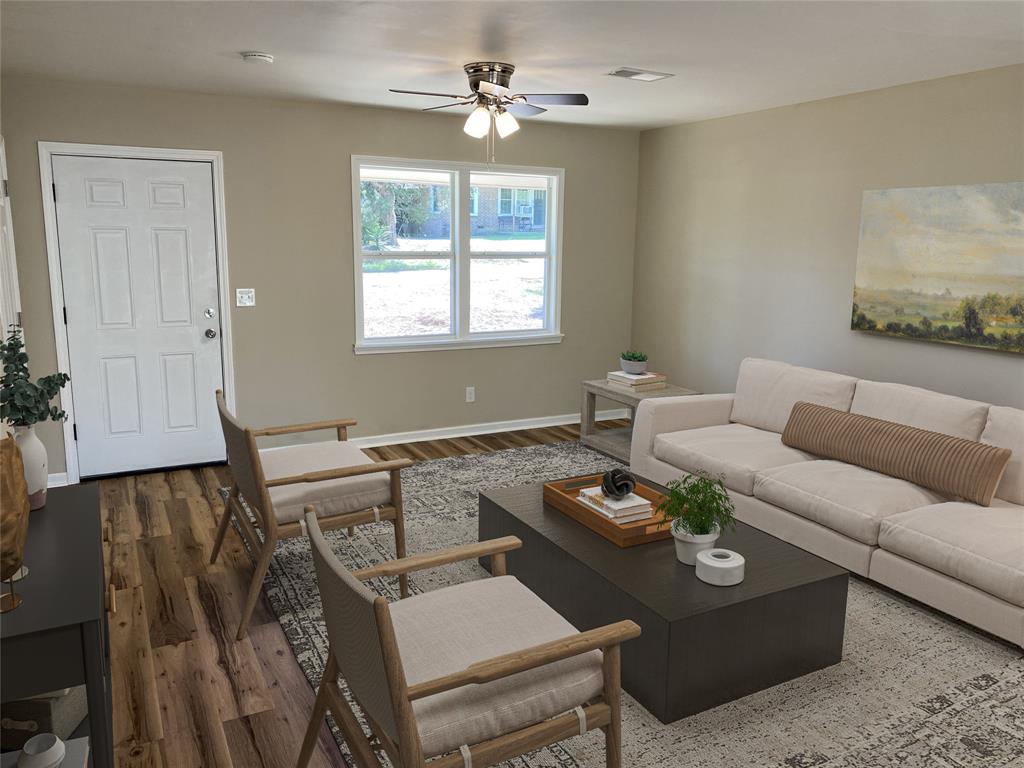 203 Elam Street Mansfield, LA 71052 - Photo 3 of 18 a living room with furniture and a window
