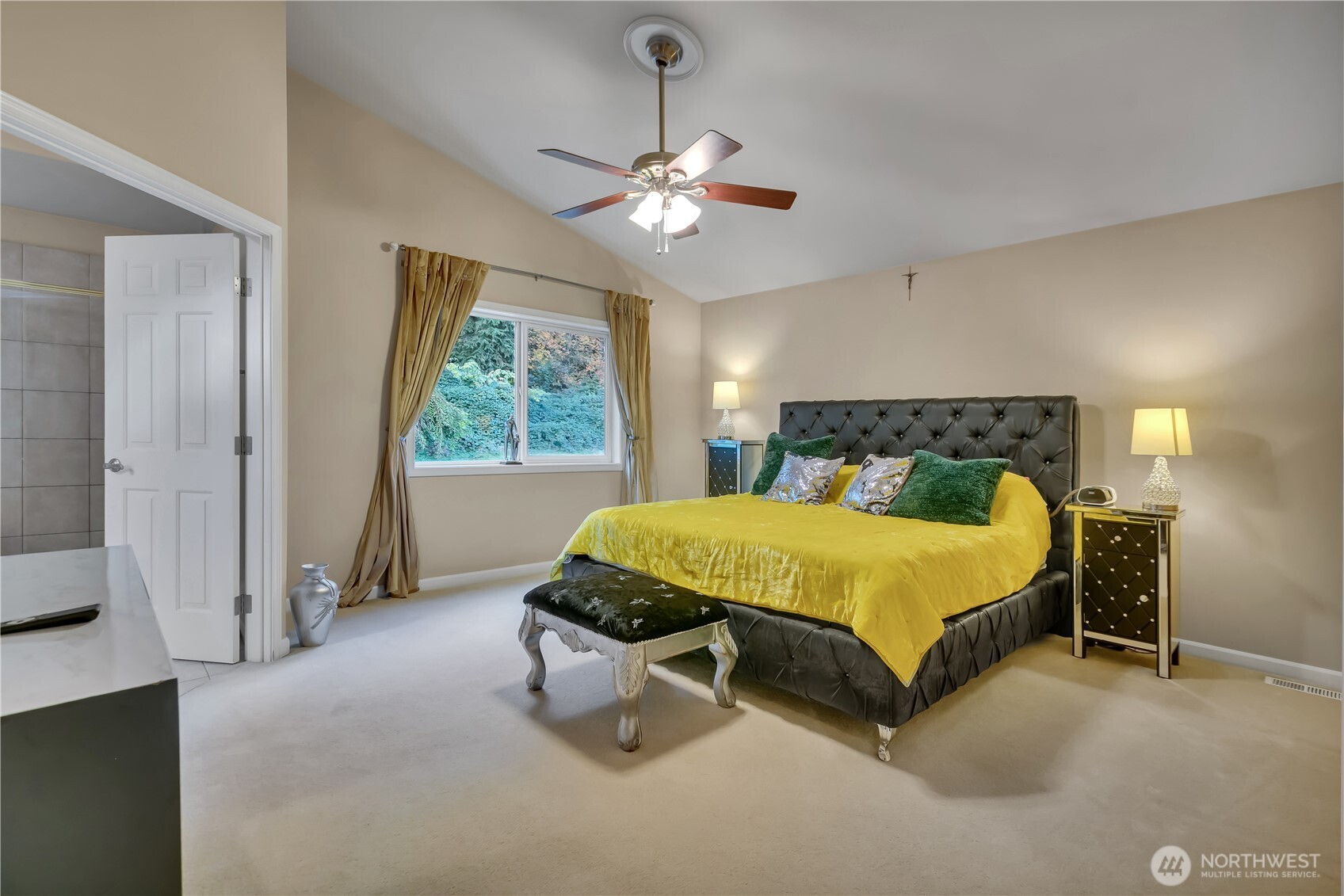 26525 Lake Fenwick Road South Kent, WA 98032 - Photo 18 of 40 a spacious bedroom with a bed and a chandelier