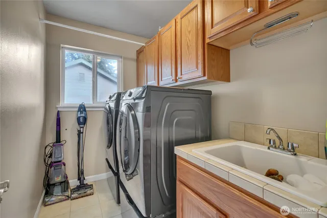 a bathroom with a tub sink and a window