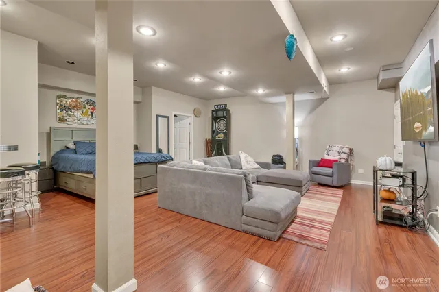 a living room with furniture and a wooden floor