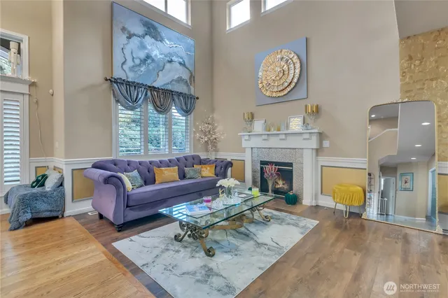 a living room with furniture a fireplace and wall paintings