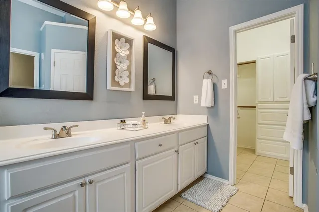 a bathroom with a double vanity sink mirror and
