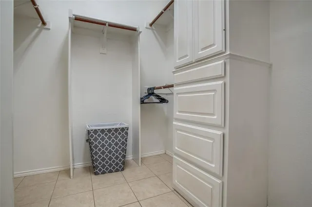 a bathroom with a walk in closet and a window