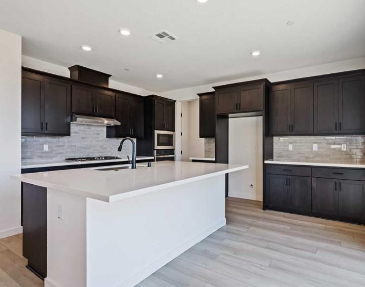 8649 Rockaway Drive Vallejo, CA 94591 - Photo 11 of 21 a large kitchen with stainless steel appliances and a refrigerator