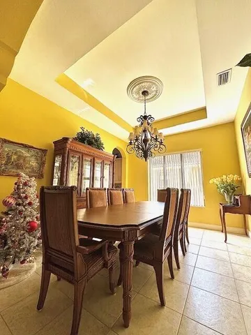 a view of a dining room with furniture and chandelier