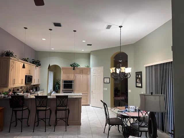 a view of a a dining room with furniture window and wooden floor