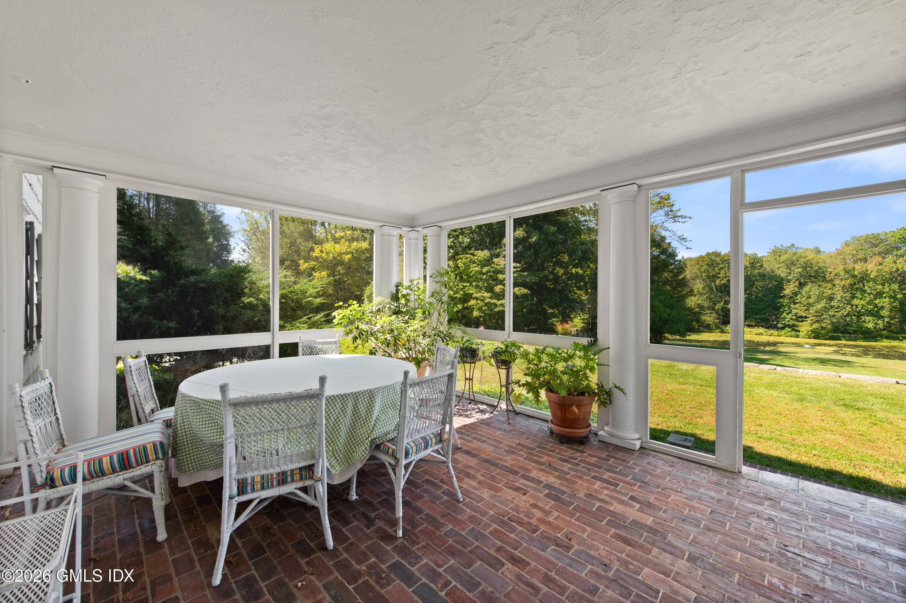 122 Round Hill Road Greenwich, CT 06831 - Photo 17 of 37 a dining room with furniture water view and a floor to ceiling window