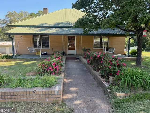 a front view of house with outdoor seating and entertaining space