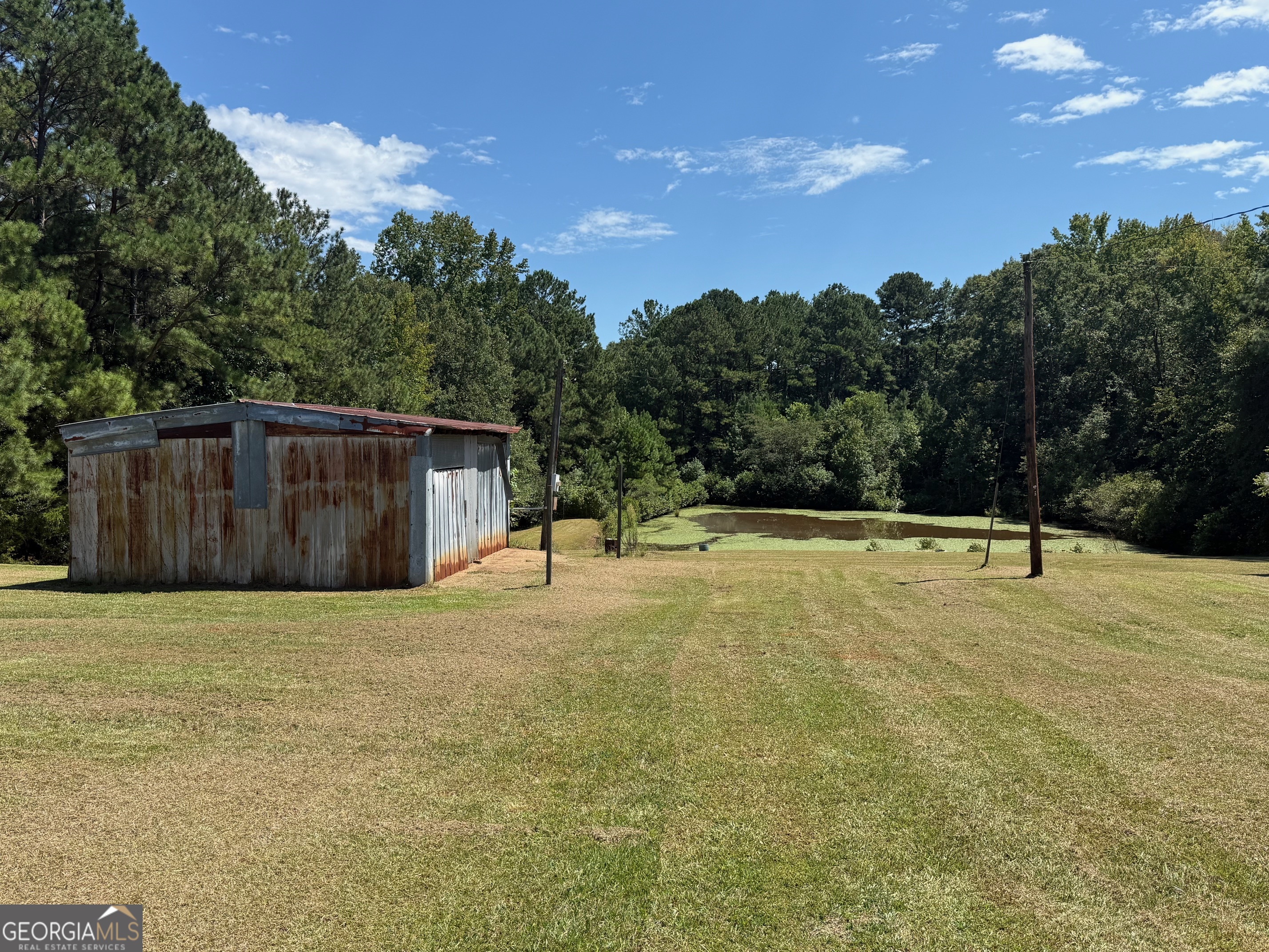 1600 Grant Avenue Manchester, GA 31816 - Photo 23 of 37 a house with trees in the background
