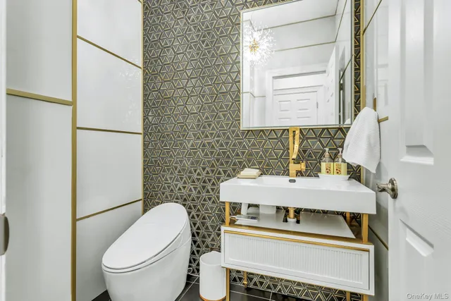 a bathroom with a sink toilet and mirror