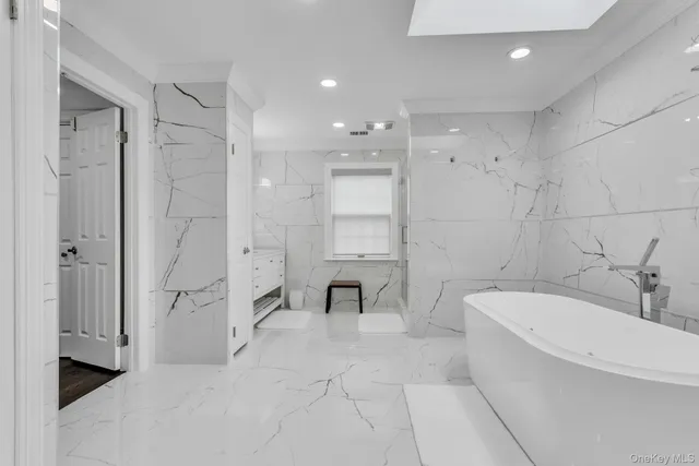 a bathroom with a bathtub shower and a toilet