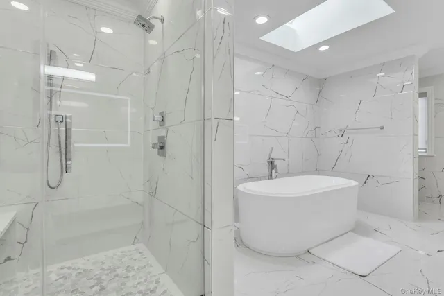 a bathroom with a bathtub and shower