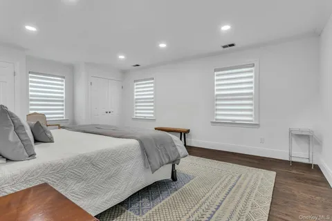 a bedroom with a large bed and a window