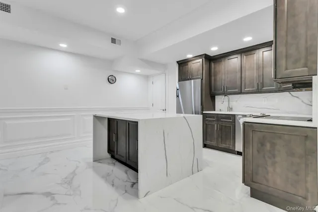 a kitchen with kitchen island cabinets and oven