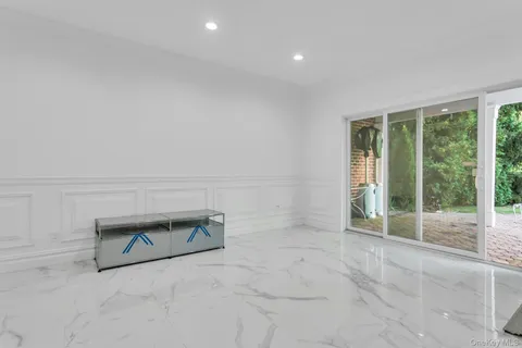 an empty room with floor to ceiling window