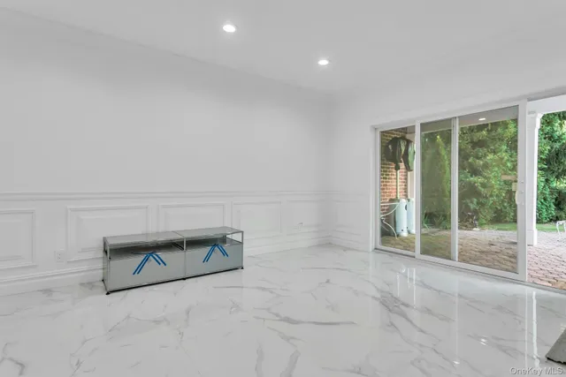 an empty room with floor to ceiling window