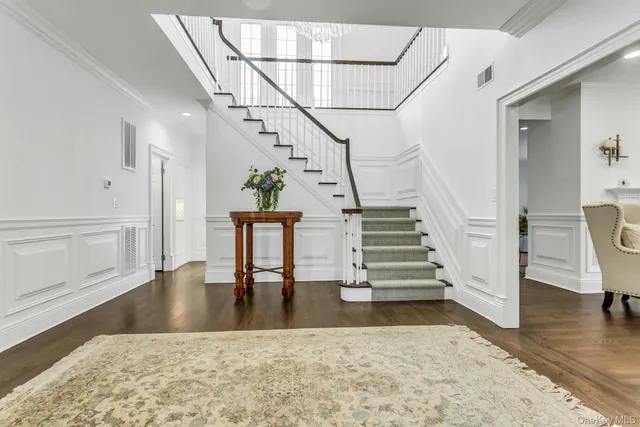 a view of entryway and hall with wooden floor
