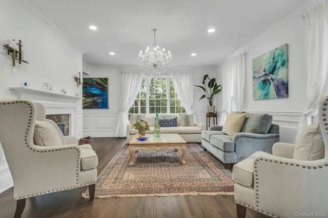 a living room with furniture and a chandelier