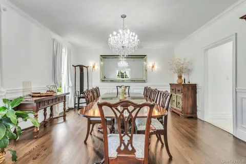 a view of a dining room with furniture wooden floor and chandelier
