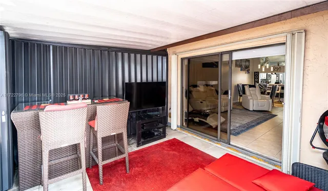 a living room with furniture a large window and a flat screen tv