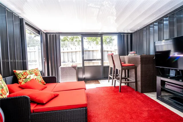 an aerial view of residential houses with outdoor space and trees