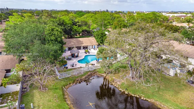 an aerial view of a pool yard swimming pool and outdoor seating