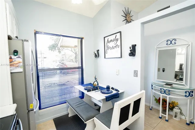 a kitchen with a sink a stove a refrigerator and white cabinets