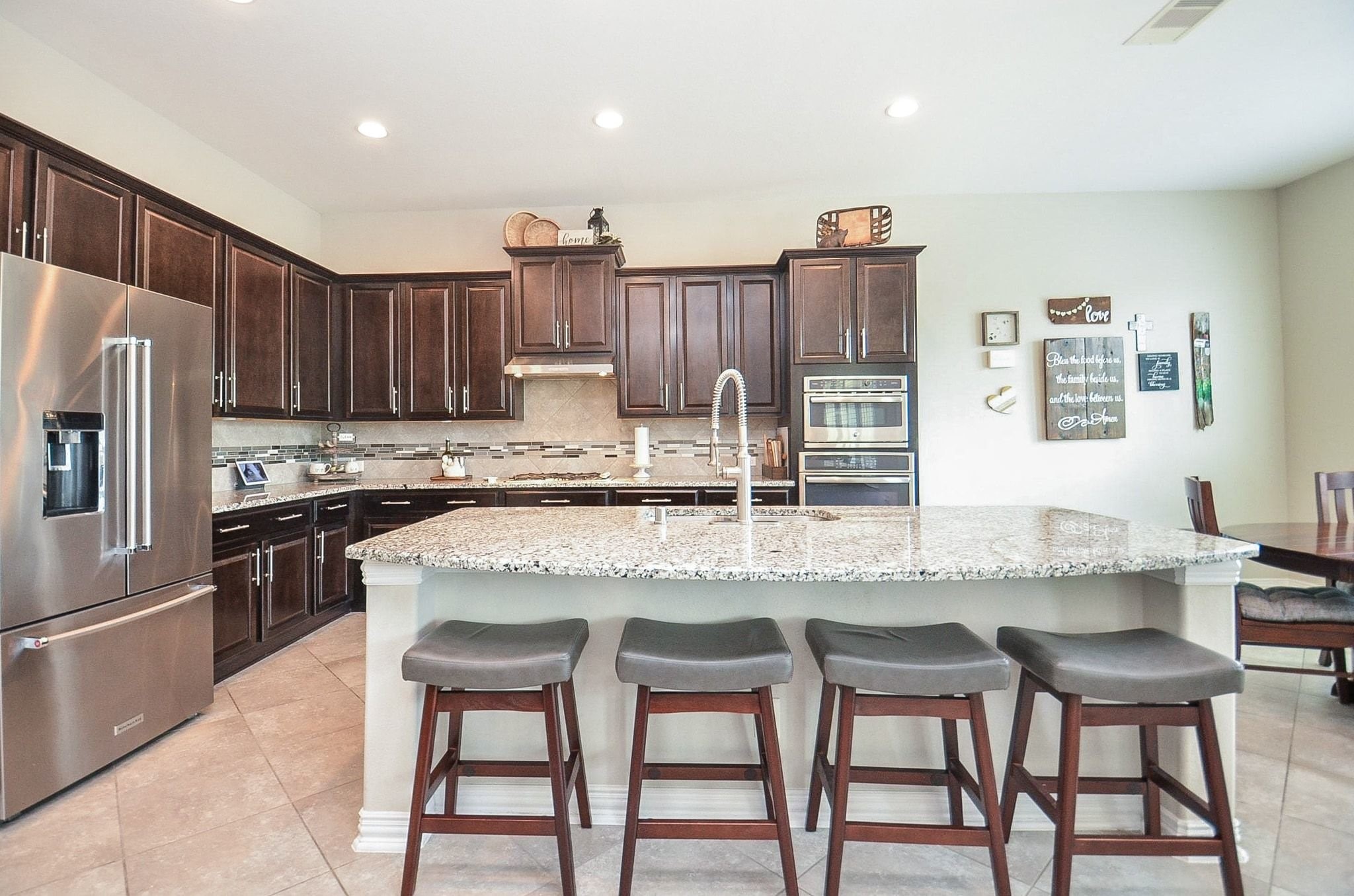 2714 Topaz Cove Lane Rosharon, TX 77583 - Photo 17 of 50 a kitchen with stainless steel appliances granite countertop a table chairs sink refrigerator and cabinets
