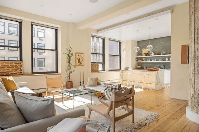a kitchen with stainless steel appliances granite countertop a stove and white cabinets with wooden floor