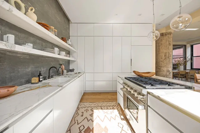 a bathroom with a glass shower door and a window