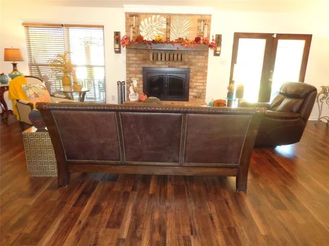 a living room with furniture a window and a fireplace