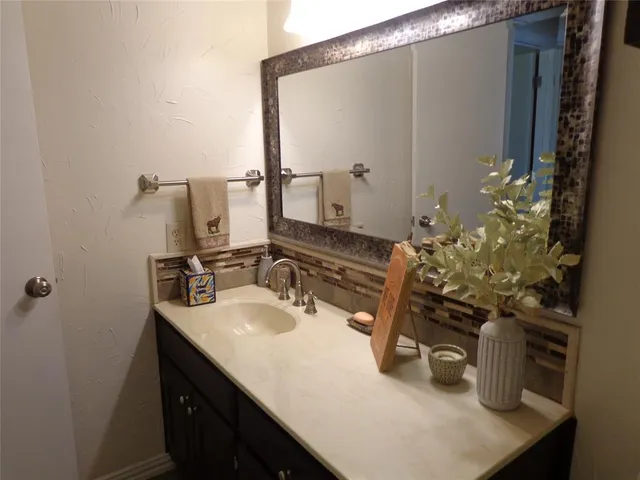 a bathroom with a glass shower door