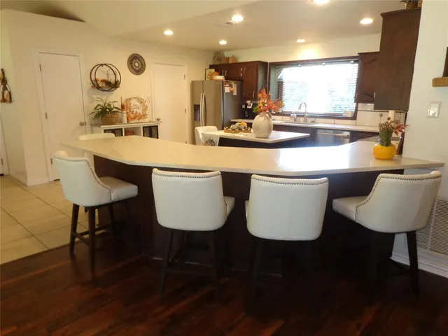 a kitchen with a table chairs sink and cabinets