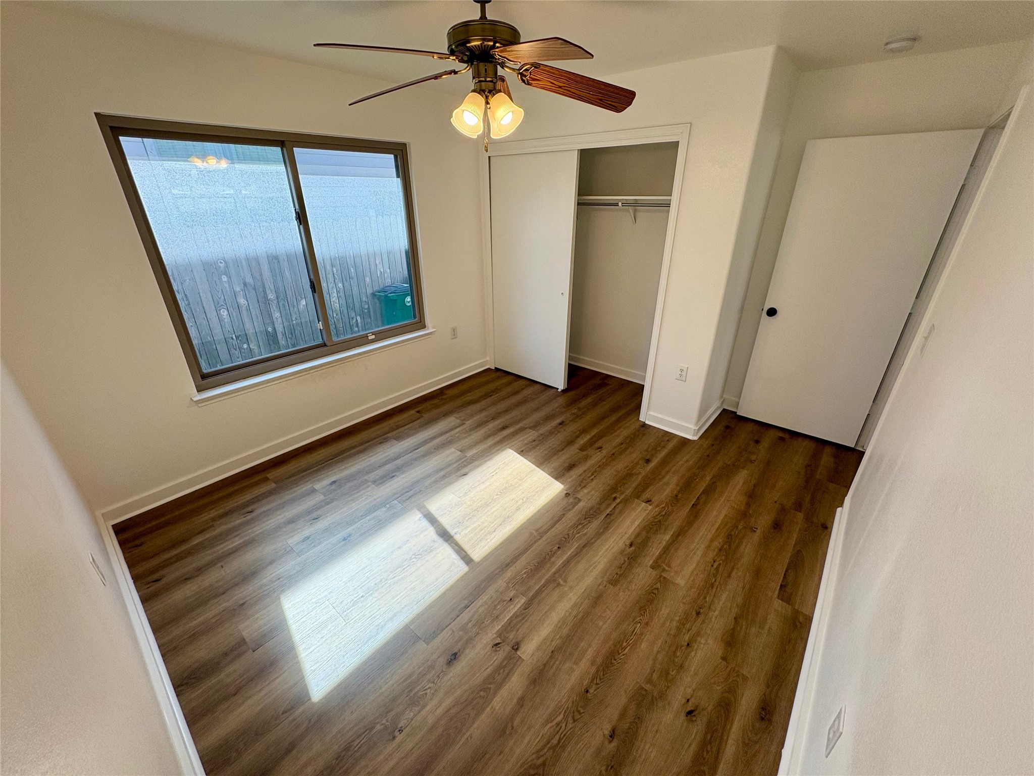 8003 Bannock Lane Austin, TX 78747 - Photo 26 of 40 Bedroom #2 featuring ceiling fan, a closet, and dark wood-style floors