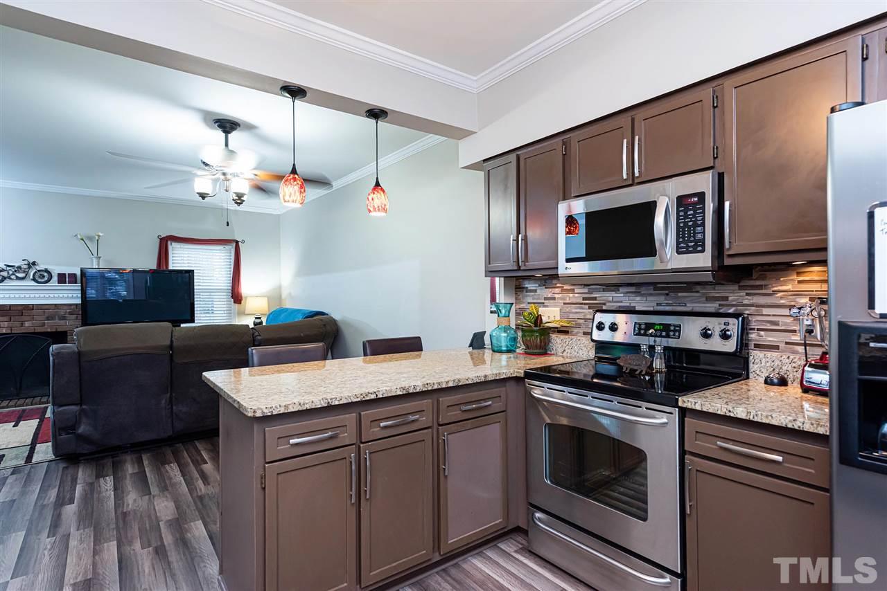 6131 Bushmills Street Raleigh, NC 27613 - Photo 8 of 14 a kitchen with a sink stove and microwave