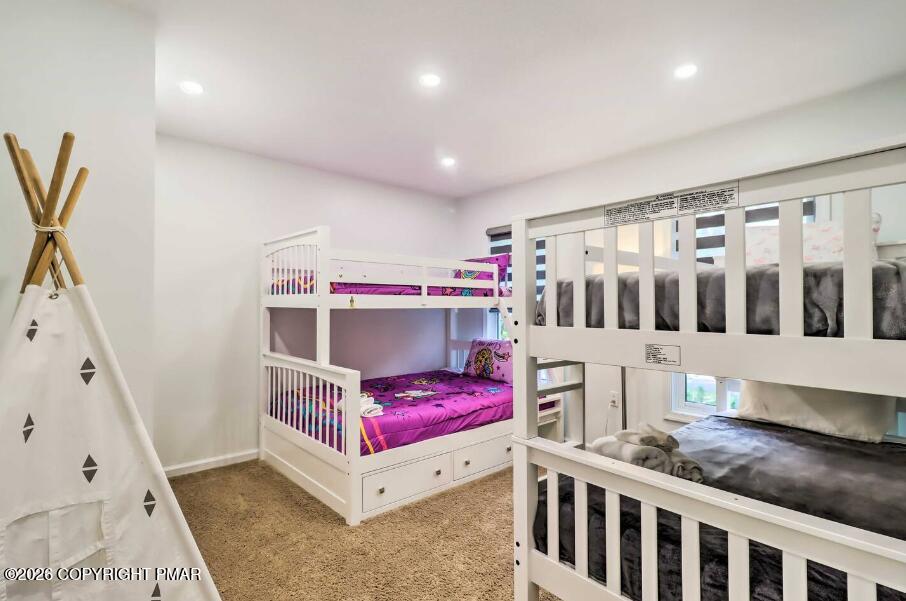 415 Alter Avenue, Unit 415 Pocono Summit, PA 18346 - Photo 12 of 21 a bedroom with furniture and a large window