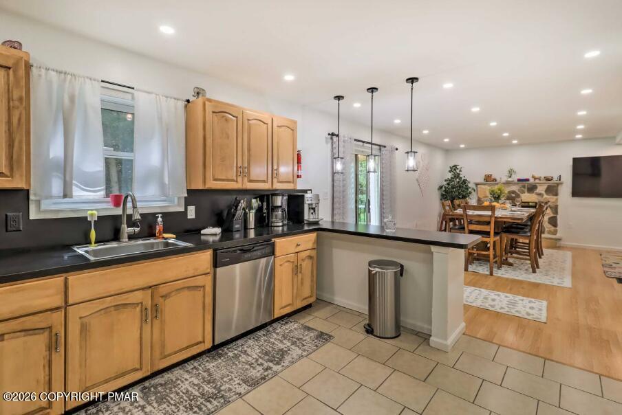 415 Alter Avenue, Unit 415 Pocono Summit, PA 18346 - Photo 6 of 21 a kitchen with granite countertop a sink and white cabinets