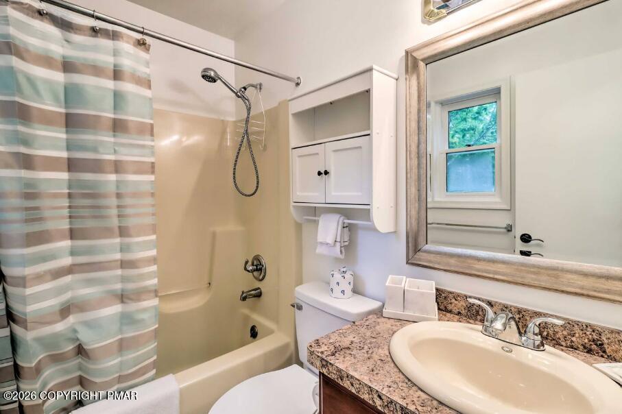 415 Alter Avenue, Unit 415 Pocono Summit, PA 18346 - Photo 9 of 21 a bathroom with a granite countertop sink a toilet and shower