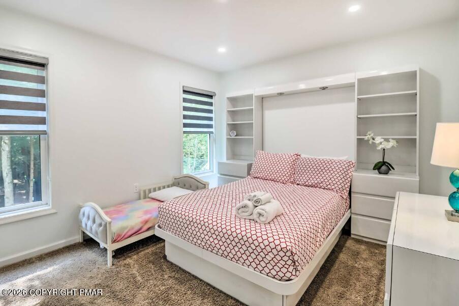 415 Alter Avenue, Unit 415 Pocono Summit, PA 18346 - Photo 10 of 21 a bedroom with a bed and a couch