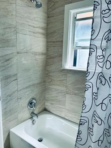 a bathroom with a shower and toilet