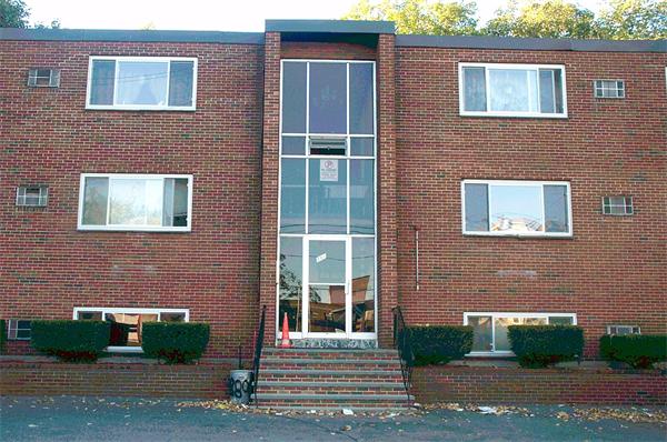 880 Broadway Chelsea, MA 02150 - Photo 1 of 18 a view of a brick house with a yard