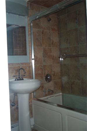 880 Broadway Chelsea, MA 02150 - Photo 12 of 18 a bathroom with a sink a toilet and shower