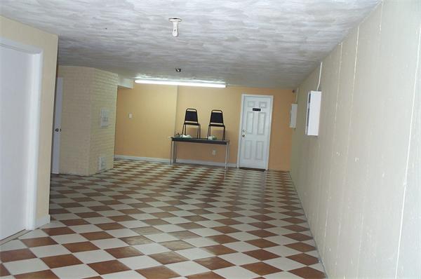 880 Broadway Chelsea, MA 02150 - Photo 17 of 18 a view of a hallway with wooden floor and a refrigerator