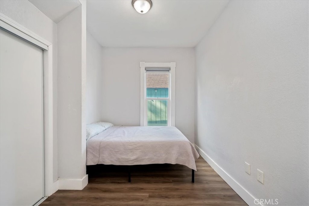 4171 9th Street Riverside, CA 92501 - Photo 11 of 19 a bedroom with a bed and wooden floor