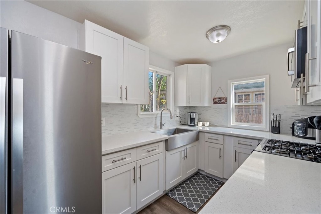4171 9th Street Riverside, CA 92501 - Photo 12 of 19 a kitchen with a refrigerator a sink and cabinets