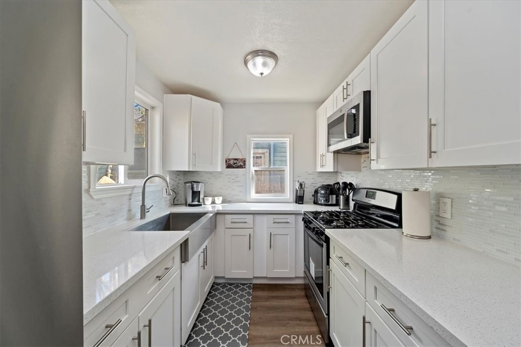 4171 9th Street Riverside, CA 92501 - Photo 13 of 19 a kitchen with a sink stove top oven and cabinets